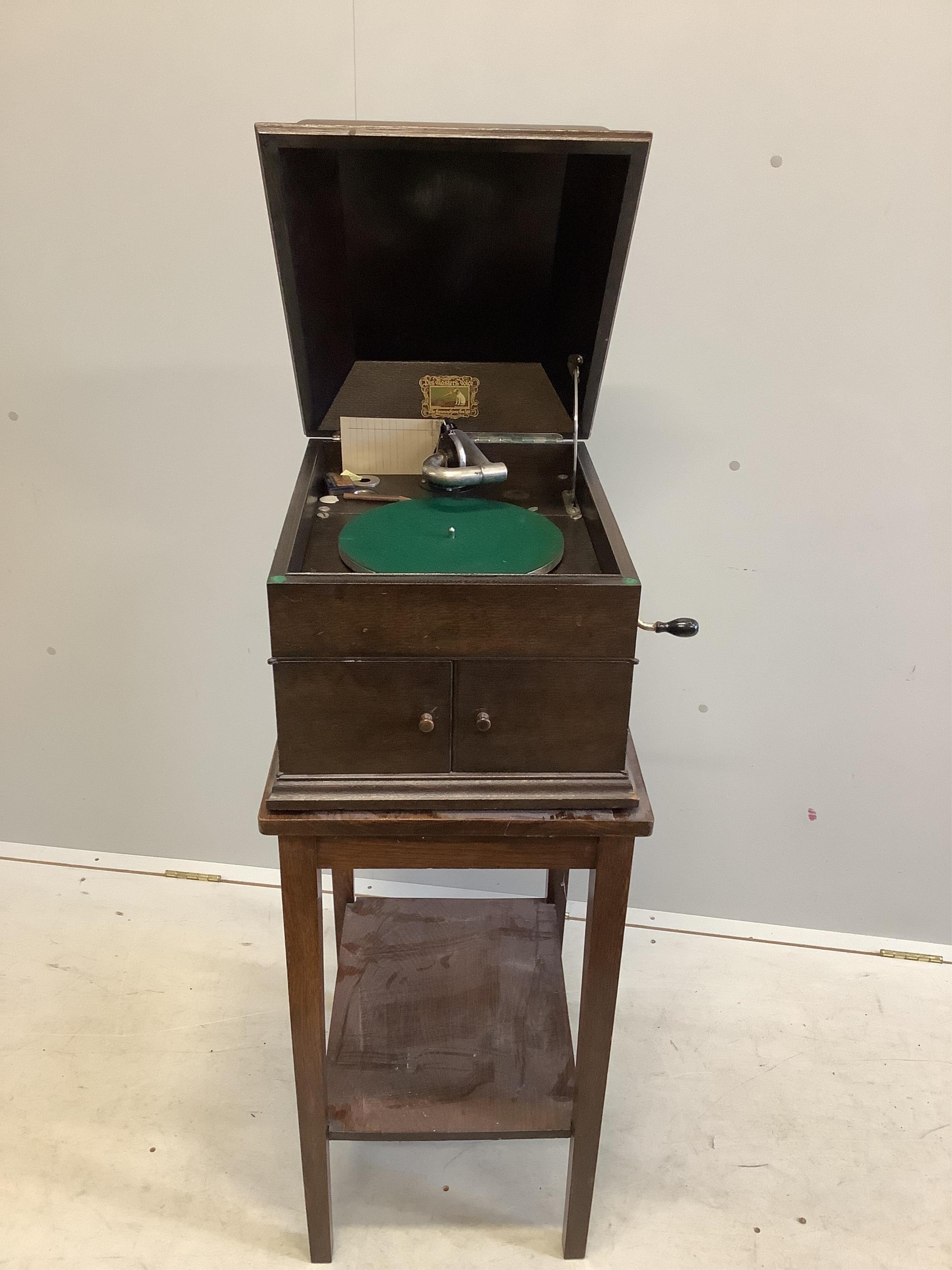 An HMV oak cased table-top gramophone on associated stand together with a collection of 78rpm records. Condition - fair